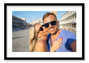 Cheerful tourists making selfie photo in Venice