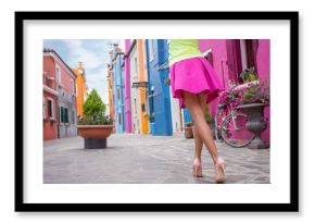 Young cheerful woman walking in streets of old town