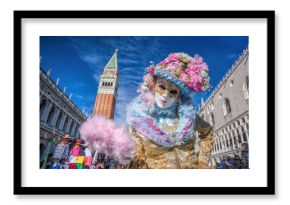 Carnival mask against bell tower on San Marco square in Venice