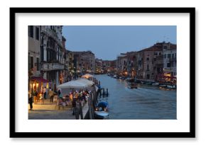 Cannaregio Canal  early  evening with  illuminated restaurants and bars Venice.