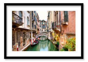 Traditional canal street with gondola in Venice, Italy