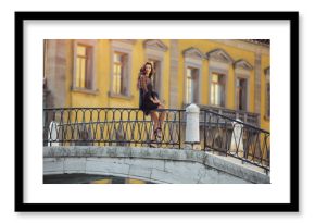 Tourist woman traveling, spending holidays in Venice, Italy. Young mixed race Asian Caucasian girl in romantic black sexy dress smiling on summer vacation in Europe, walking beautiful Italian Canal