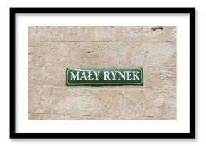 Mały Rynek street name sign in the Old Town district of Krakow, Poland. Information plate on building wall in Kraków. Little Market or the Small Square of Cracow.