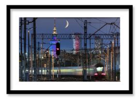 Partial moon over Warsaw city and train junction