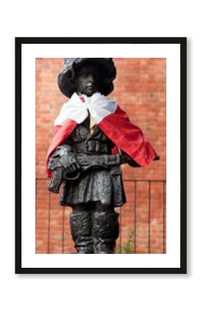 Boy-Soldier statue in Warsaw city walls. Old Town. Poland