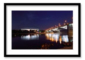 Poniatowski Bridge and National Stadium in Warsaw by night.