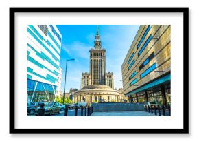 Palace of culture and science in Warsaw on sunny day with blue sky and green trees. 