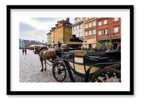 A man with a traditional carriage waits for tourists in the old town of Warsaw, Poland.