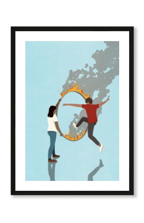 Man jumping through burning hoop for woman 