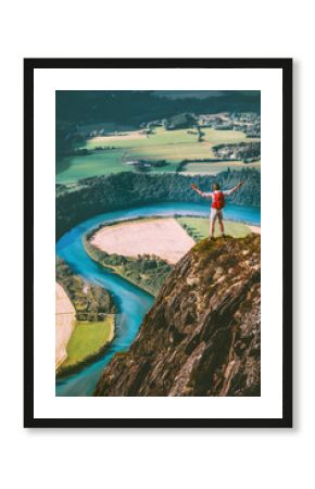 Happy Man traveler standing on cliff mountain hands raised Travel Lifestyle success motivation concept adventure active vacations outdoor river aerial view