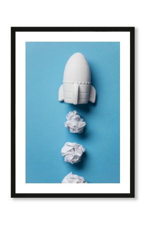 Business startup concept. Rocket taking off with crumpled paper trail