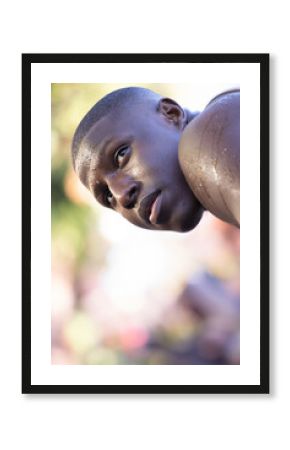 African American man perspiring in park while looking toward right, radiating energy, copy space