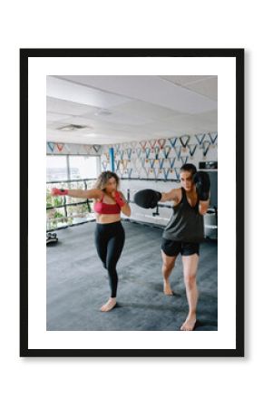 Women Practicing Boxing Techniques Together in a Gym Environment