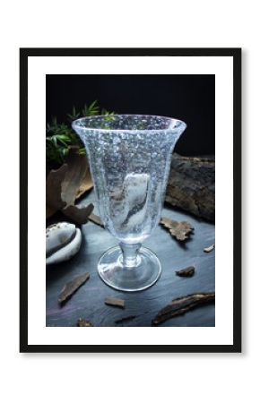 Empty bubble glass on dark beach motive background.