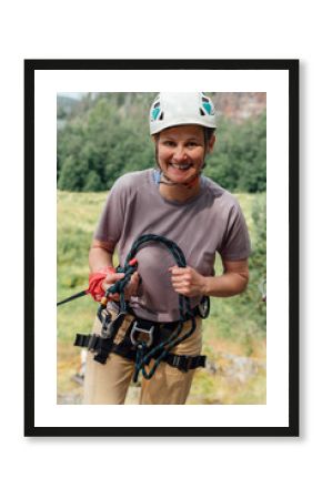 Smiling Female Climber Holding Rope and Gear Outdoors
