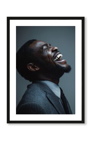 Businessman tilting his head back and laughing joyfully, expressing relief and freedom after tension.