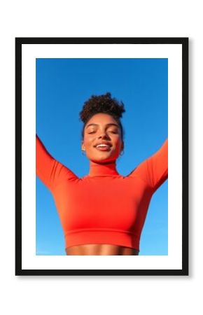 Diverse Active Lifestyle Portrait Young Woman in Vibrant Orange Yoga Top Against Clear Sky - Fitness Motivation and Digital Branding for Health and Wellness