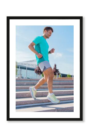 Man jogging down outdoor stairs in athletic wear during bright sunny day at modern urban park