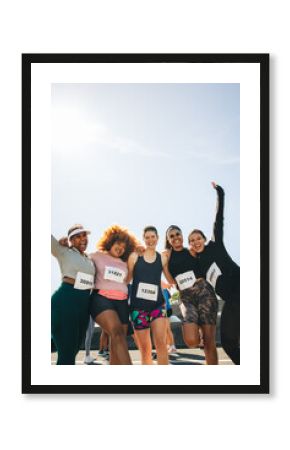 Group of female friends celebrate after finishing a 5km race