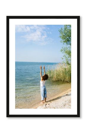 Solitary woman meditating by the sea