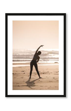 Unrecognizable woman stretching on beach