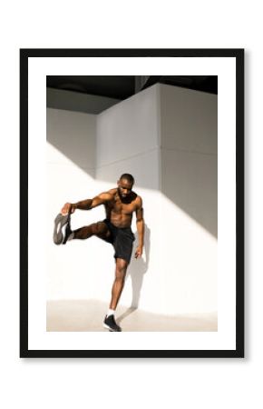 Portrait of a young handsome athlete with a naked torso 
