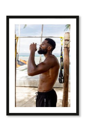 Portrait of man drinking water during workout in the gym