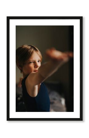 Determinant boy with arms outstretched exercising at home