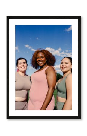 Portrait of three curvy friends of different ethnicities in a park