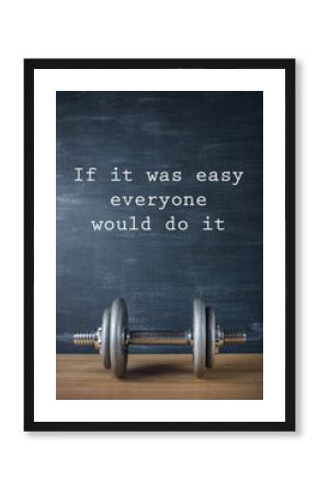 metal barbell on dark gray background and motivation text