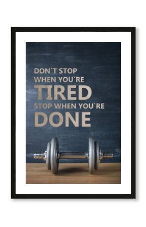metal barbell on dark gray background and motivation text