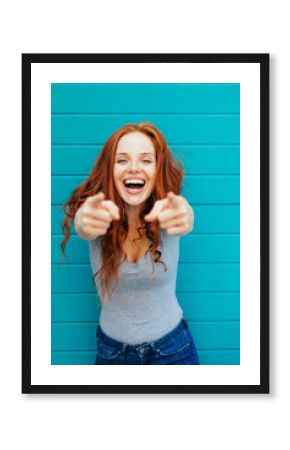 Vivacious laughing woman pointing at camera