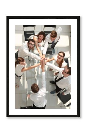 top view.the company's employees are giving each other high five