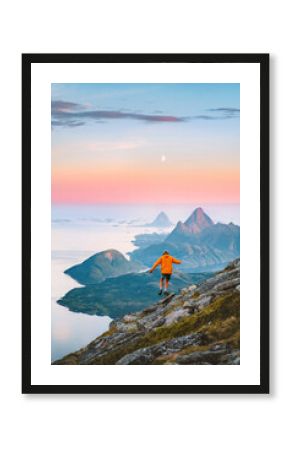 Travel in Norway - man hiking solo in mountains active adventure summer vacations, tourist exploring wild Scandinavian nature healthy lifestyle freedom concept islands and sea landscape moon and dawn