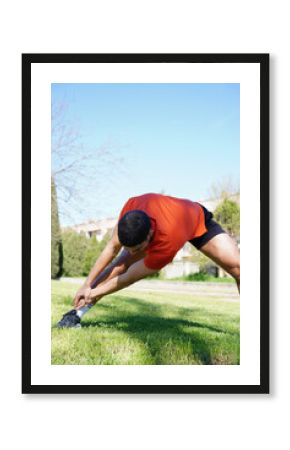 Young man stretching as part of daily fitness routine