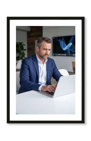 Business professional working on laptop in modern office environment focused viewpoint productivity concept