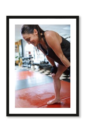 Fit Woman Taking a Break During Intense Workout in Gym Setting