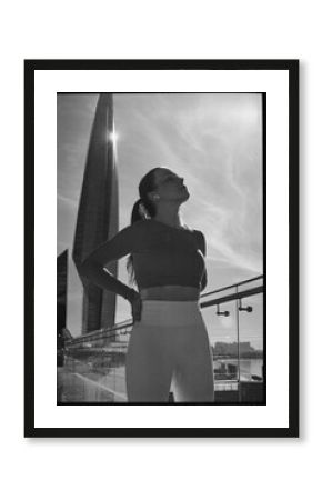 Woman resting after jogging against cityscape backdrop