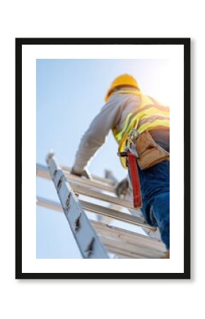 Worker climbing ladder against clear sky, showcasing determinati