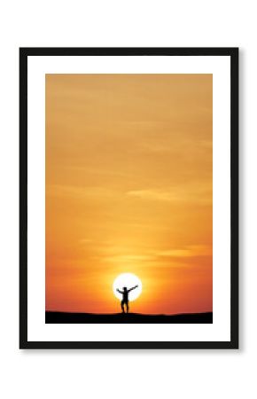Silhouette of a person embracing Sunset: An emotive silhouette of a person stretches towards the vast, fiery sun, their arms wide open in a gesture of pure freedom.