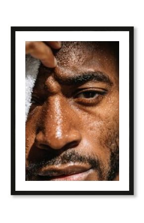 Businessman wiping sweat from his forehead, symbolizing stress, relief, and perseverance.