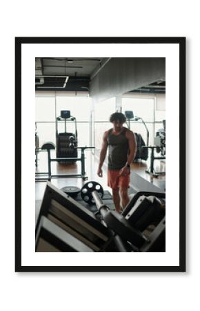 Young Man Using Gym Equipment
