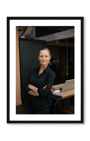 Confident professional woman standing in modern workspace