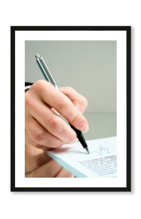 Photo of ballpoint in the female hand over a contract