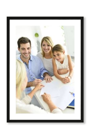 Family signing contract with home seller