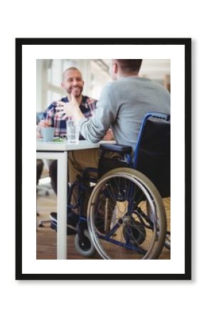 Happy handicap businessman discussing with colleague
