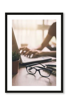 Businesswoman typing on laptop at workplace