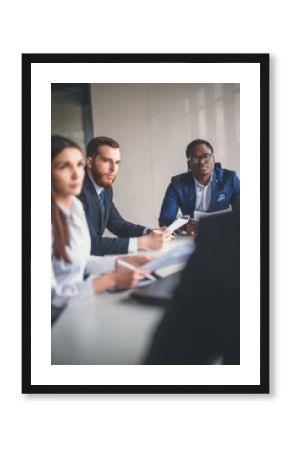 Vertical image of business colleagues cooperating to achieve better results for their company