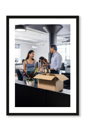 Colleagues discussing project in modern office with open workspace and natural light