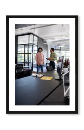 Business professionals discussing project in modern office with digital tablet